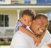 Father with Son Near House - Homeowners Insurance